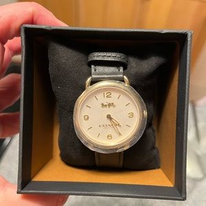 Brand new Coach wrist watch with black leather band. Includes tags and box.